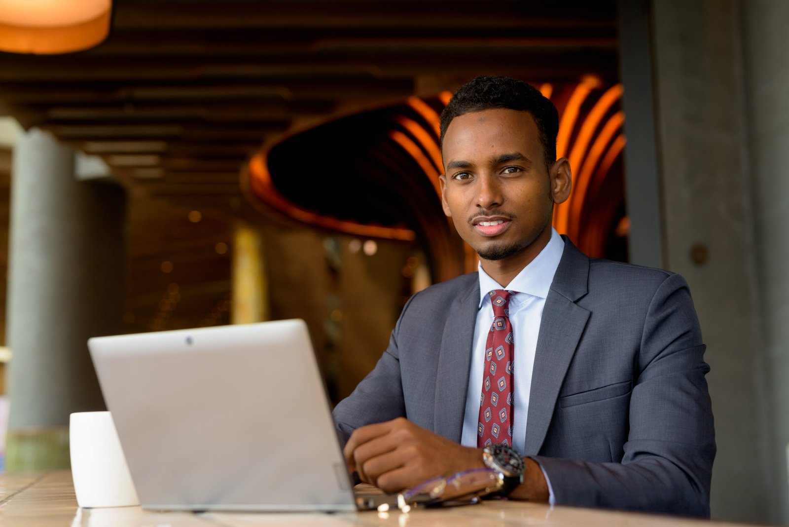 Portrait of African businessman wearing suit and tie in coffee shop